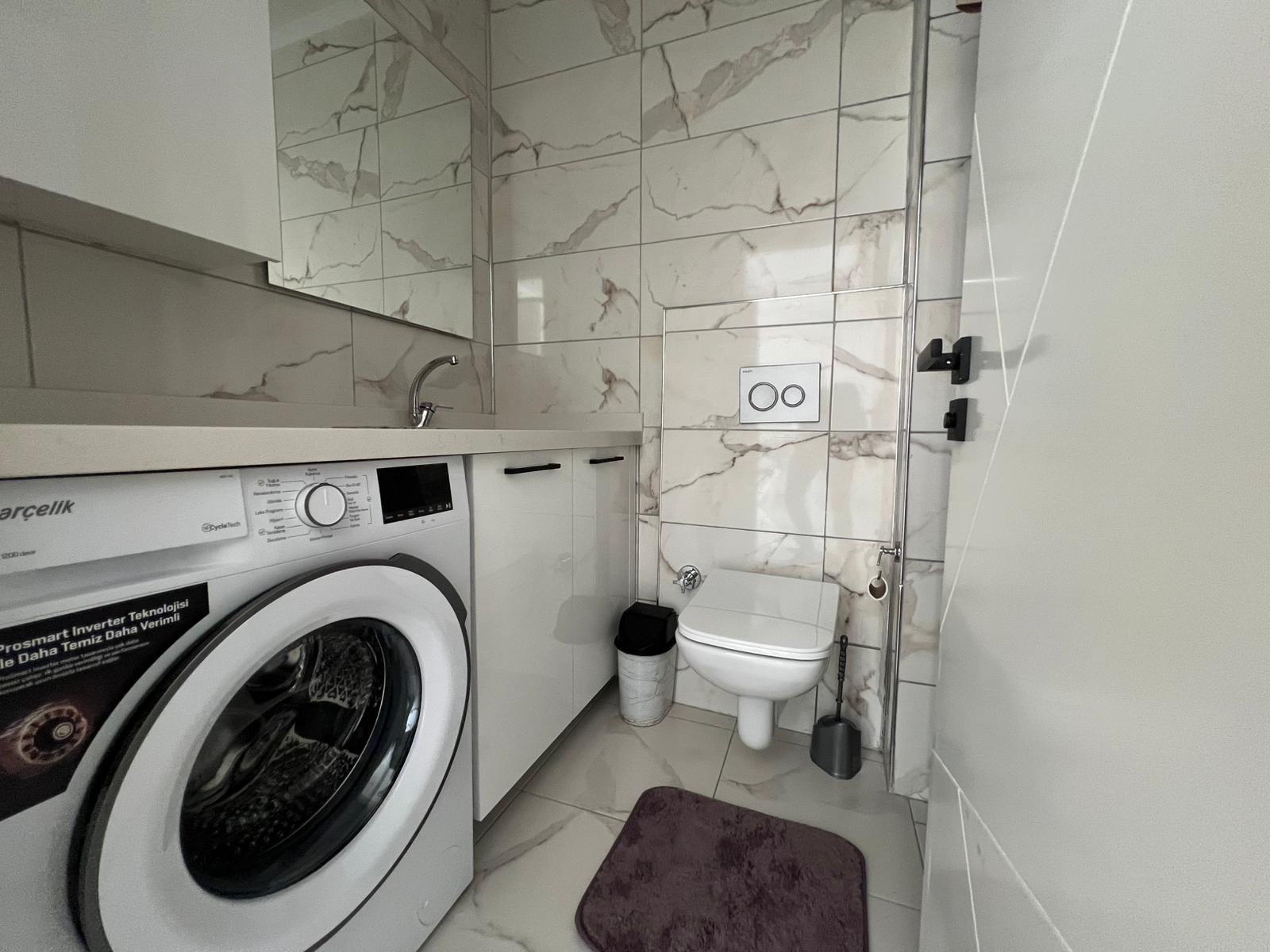 Уютная двухкомнатная квартира в живописном районе Махмутлар Алания. - Фото 25