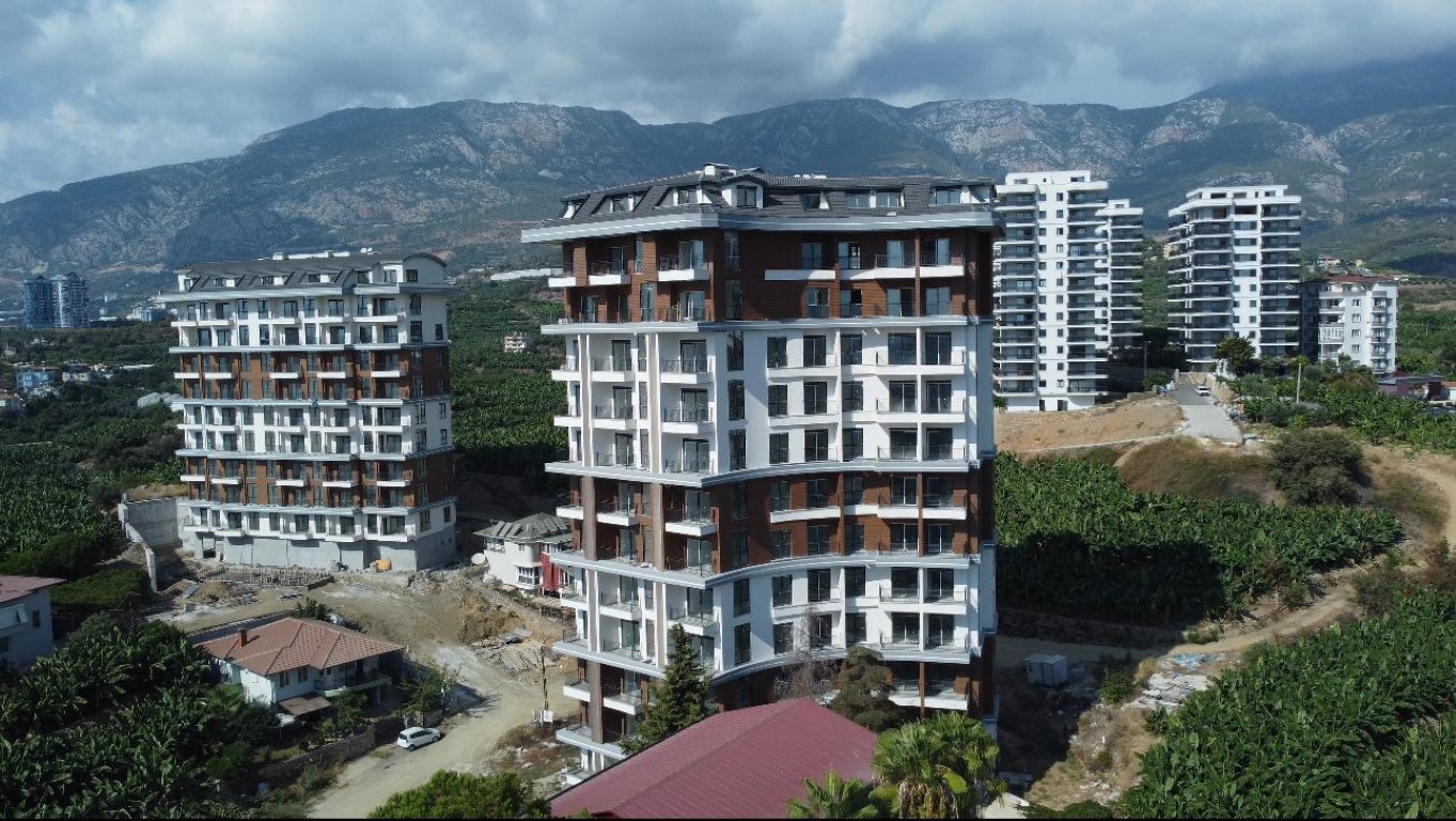 Квартира планировкой 2+1 с видом на море и город в районе Махмутлар Аланья. 